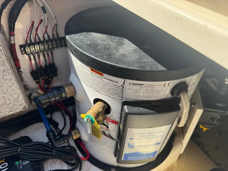 Slide: The Image of 1999 Boston Whaler 28 Conquest boat interior showing Raritan water heater and wiring. - 40