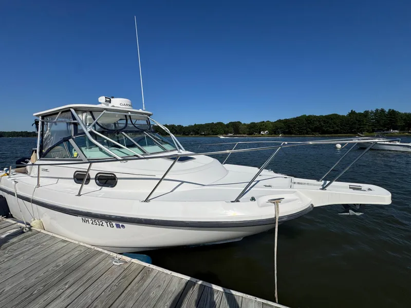 Slide: The Image of 1999 Boston Whaler 28 Conquest boat docked on a sunny day. - 5