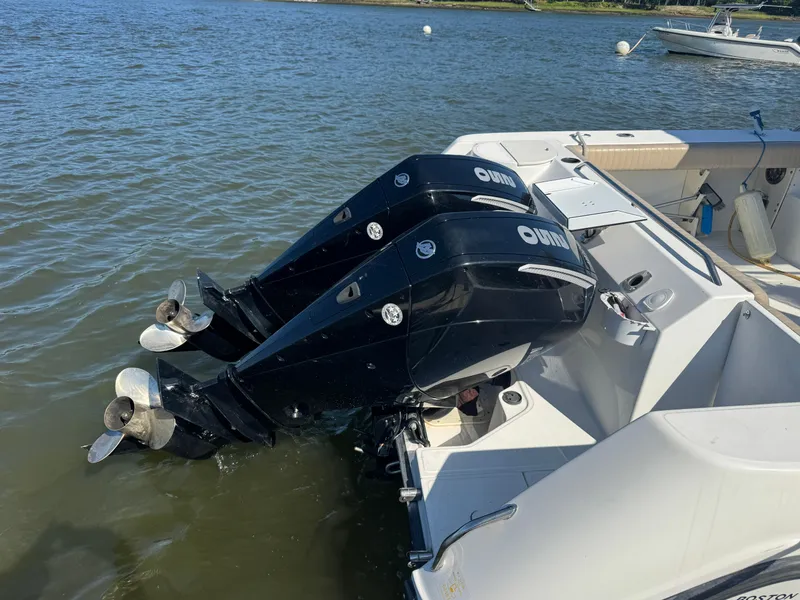 Slide: The Image of 1999 Boston Whaler 28 Conquest with dual outboard engines on water. - 9
