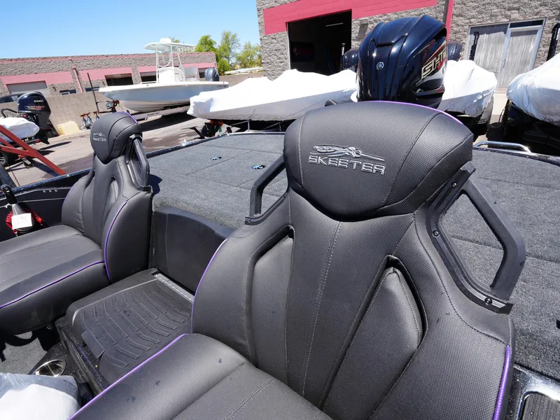 Slide: The Image of 2025 Skeeter ZXR20 boat seats with sleek design and logo detailing. - 13