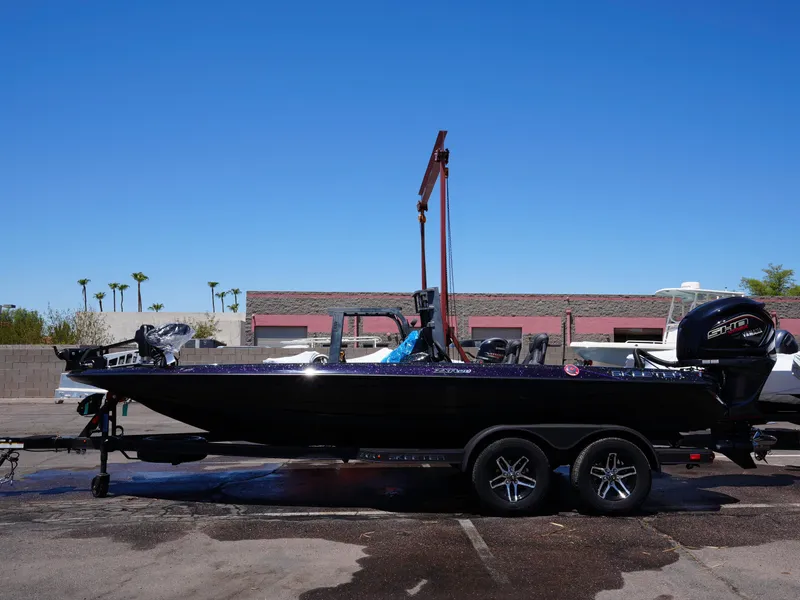 Slide: The Image of 2025 Skeeter ZXR20 boat on trailer under clear blue sky. - 2