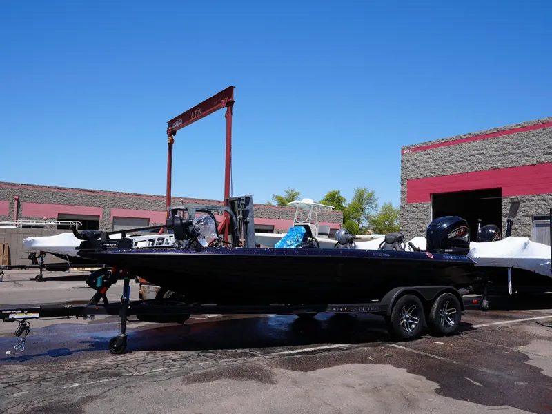 Slide: The Image of 2025 Skeeter ZXR20 boat with Yamaha engine on trailer under clear blue sky. - 3