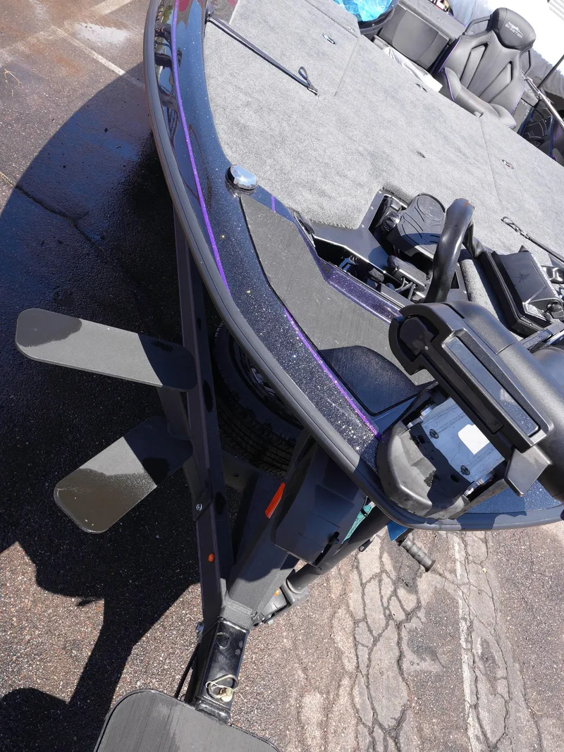 Slide: The Image of 2025 Skeeter ZXR20 boat deck with trolling motor and seating, on a sunny day. - 6