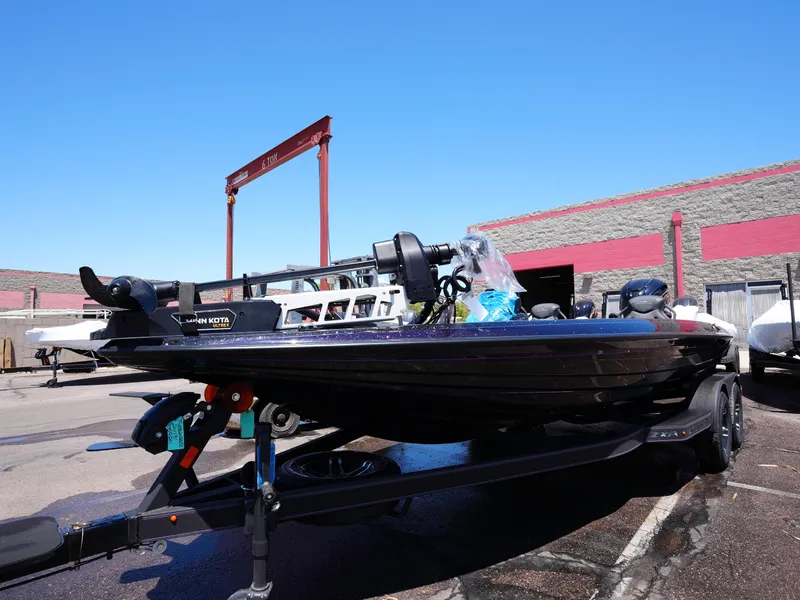 Slide: The Image of 2025 Skeeter ZXR20 boat on trailer in outdoor lot, clear blue sky. - 7