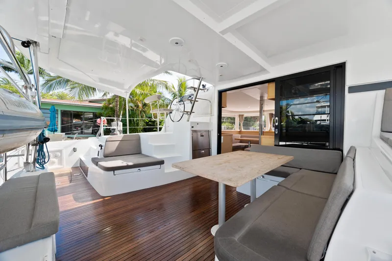 Slide: The Image of 2017 Lagoon 42 catamaran docked in a tropical marina setting. - 15