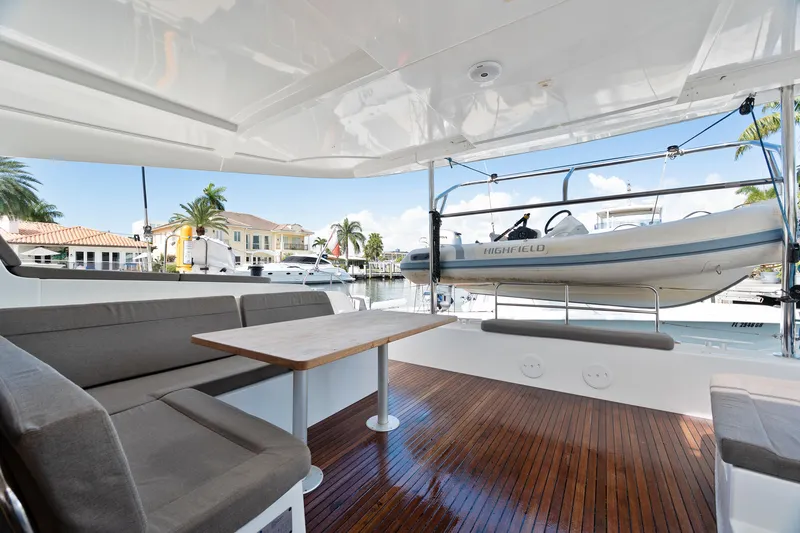 Slide: The Image of 2017 Lagoon 42 catamaran docked in a scenic marina with lush surroundings. - 17