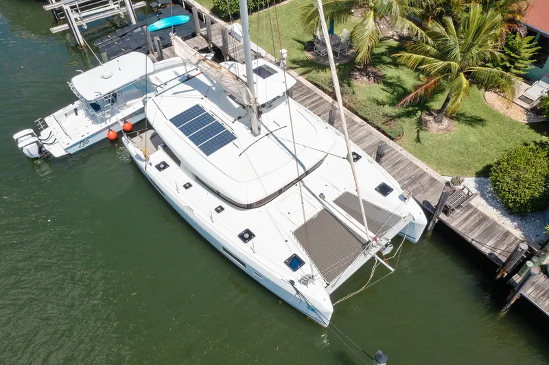 Slide: The Image of 2017 Lagoon 42 Owners Version catamaran docked in a marina. - 6