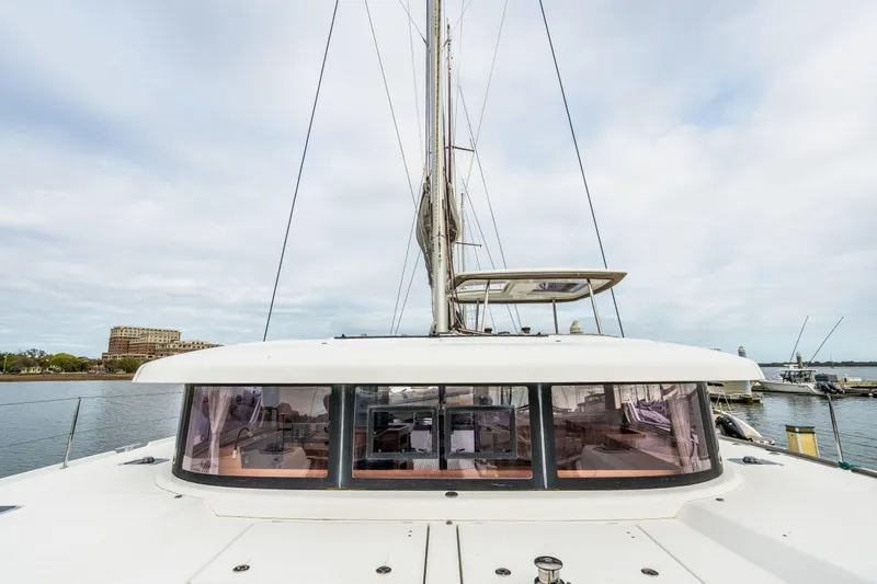 Slide: The Image of Docked sailboats including a 2017 Lagoon 42 catamaran at a marina. - 85