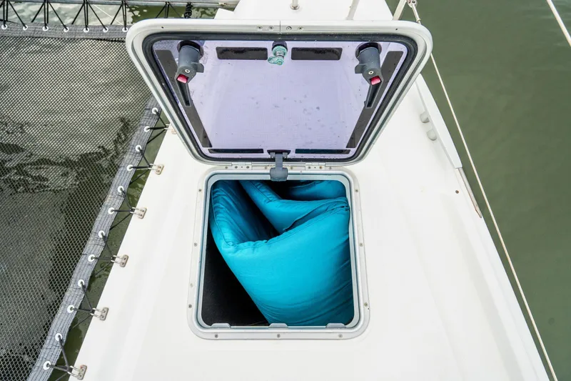 Slide: The Image of Docked Lagoon 42 catamarans from 2017 at a marina, under a clear sky. - 86