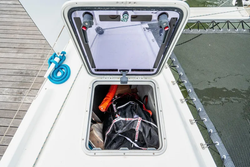 Slide: The Image of 2017 Lagoon 42 catamaran docked at marina, surrounded by other boats. - 87