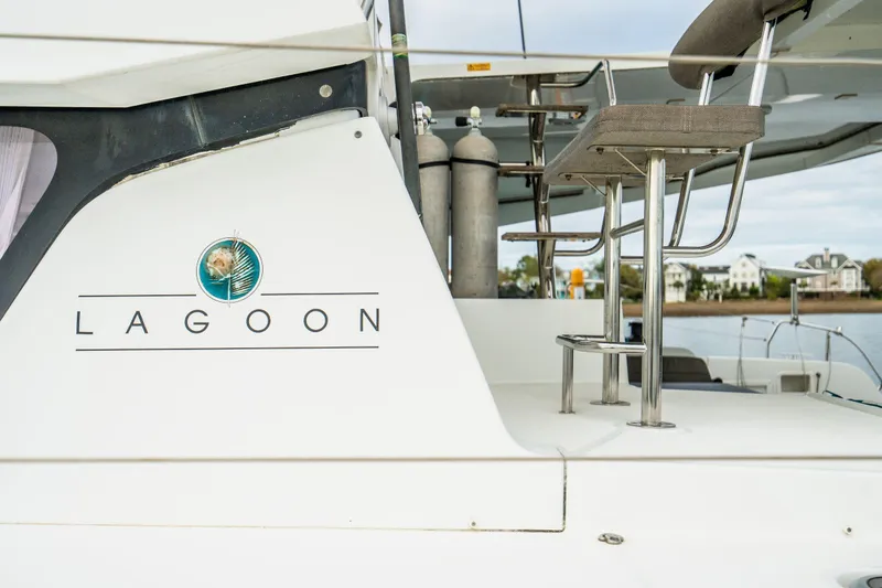 Slide: The Image of 2017 Lagoon 42 catamaran docked at marina, featuring solar panels and spacious deck. - 89