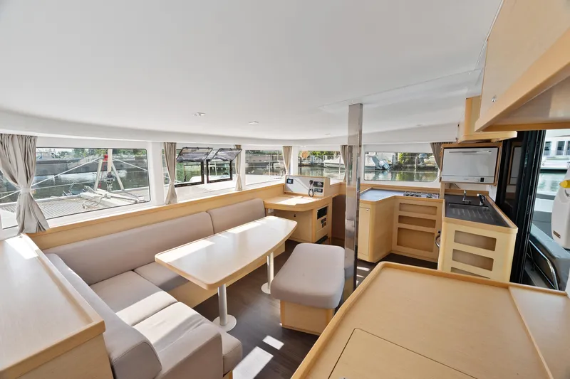 Slide: The Image of Interior of 2017 Lagoon 42 catamaran, featuring modern kitchen and dining area with ample natural light. - 22