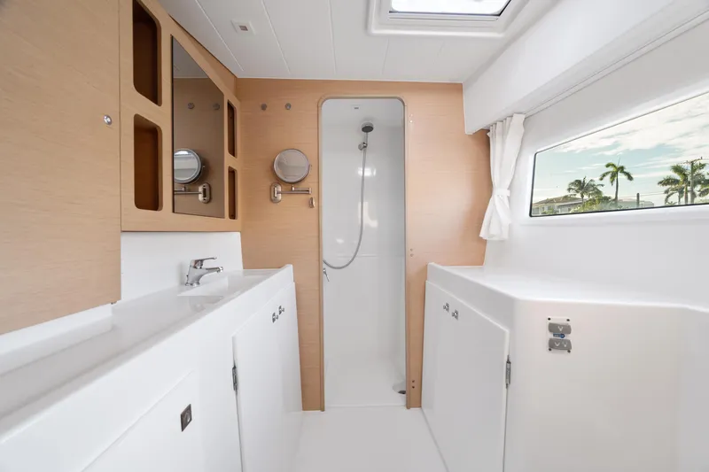 Slide: The Image of Control panel of a 2017 Lagoon 42 yacht, featuring various switches and gauges. - 29