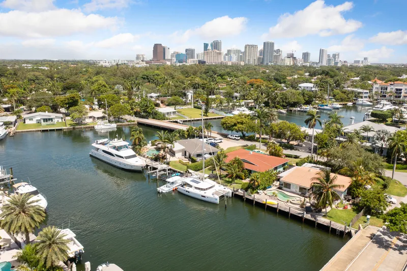 Slide: The Image of 2017 Lagoon 42 Owners Version catamaran docked at marina with other boats. - 3