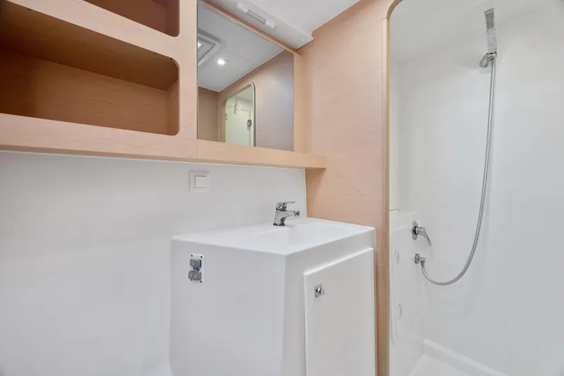 Slide: The Image of Interior of 2017 Lagoon 42 catamaran with modern wood finish and cozy sleeping area. - 33