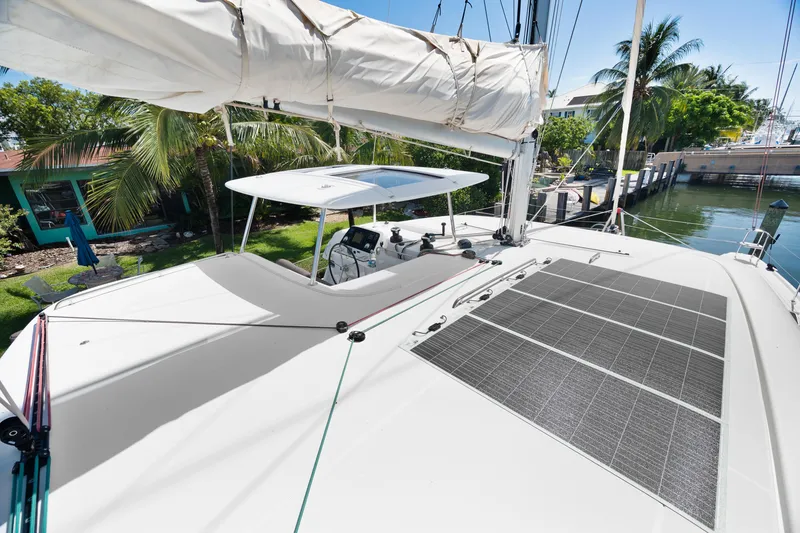 Slide: The Image of 2017 Lagoon 42 catamaran helm station with marina view, featuring modern design and equipment. - 54