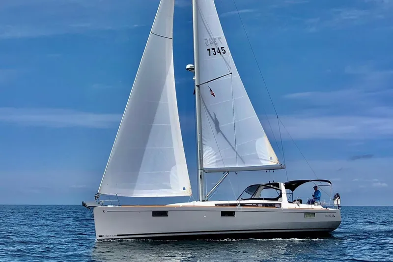 The Image of 2016 Beneteau Oceanis 473 sailing on open sea under clear blue sky. - 0