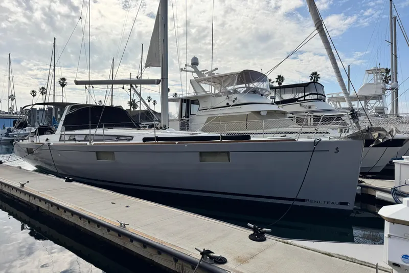 Slide: The Image of 2016 Beneteau Oceanis 48 yacht docked at marina under cloudy sky. - 1