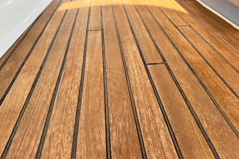 Slide: The Image of Teak deck of 2016 Beneteau Oceanis 48 sailboat, showcasing elegant wood grain. - 10