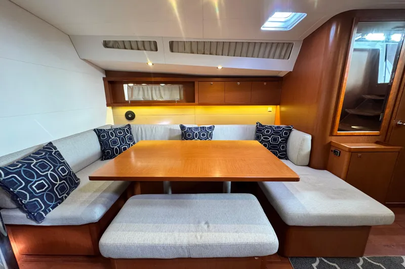 Slide: The Image of Interior of 2016 Beneteau Oceanis 48 yacht with cozy dining area and modern design. - 14