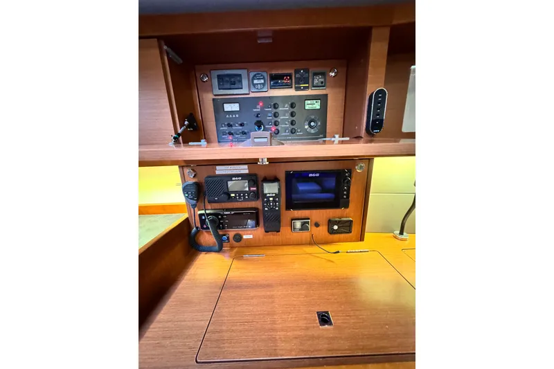 Slide: The Image of Control panel of a 2016 Beneteau Oceanis 48 yacht, featuring navigation and communication equipment. - 16