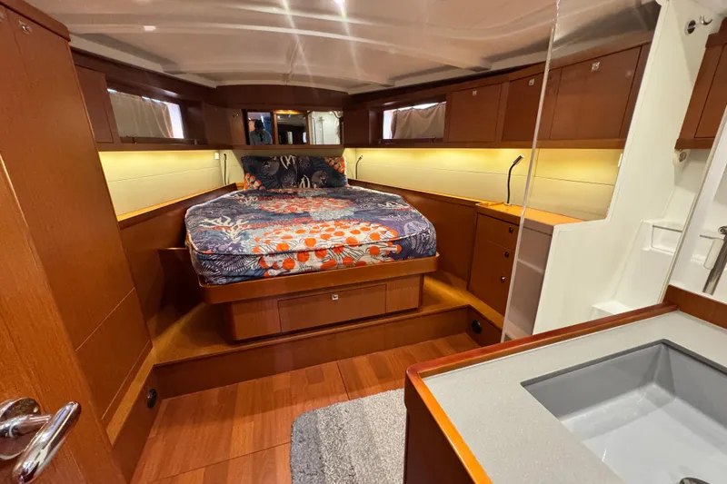 Slide: The Image of Luxurious cabin interior of 2016 Beneteau Oceanis 48 yacht with cozy bed and wooden finish. - 17