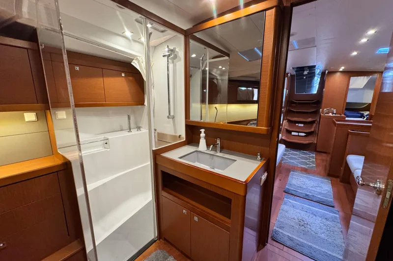 Slide: The Image of Luxurious interior of 2016 Beneteau Oceanis 48 yacht with modern bathroom and wooden finishes. - 18