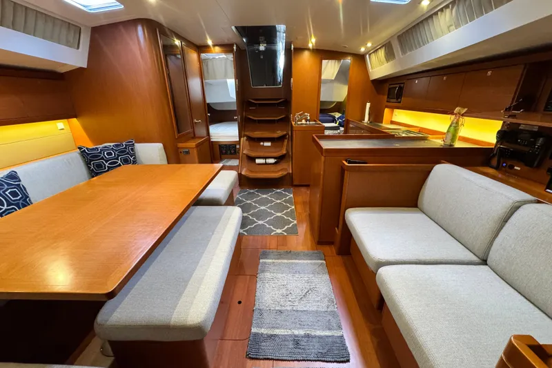 Slide: The Image of Luxurious 2016 Beneteau Oceanis 48 yacht interior with elegant wood finish and cozy seating. - 19