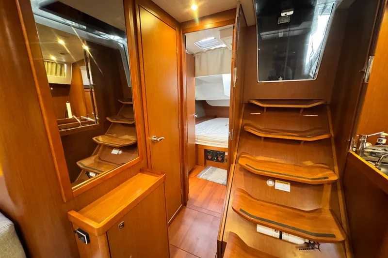 Slide: The Image of Interior of 2016 Beneteau Oceanis 48 yacht with wooden stairs and cozy cabin. - 20
