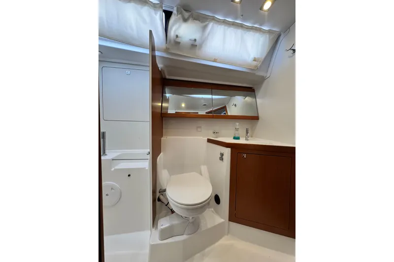 Slide: The Image of 2016 Beneteau Oceanis 48 yacht bathroom with modern fixtures and wooden cabinetry. - 24