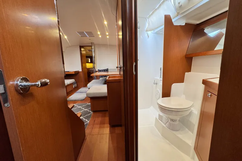 Slide: The Image of Interior of 2016 Beneteau Oceanis 48 yacht, featuring a cozy cabin and modern bathroom. - 26