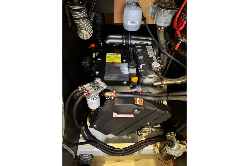Slide: The Image of Engine compartment of a 2016 Beneteau Oceanis 48 sailboat, showcasing mechanical components. - 28