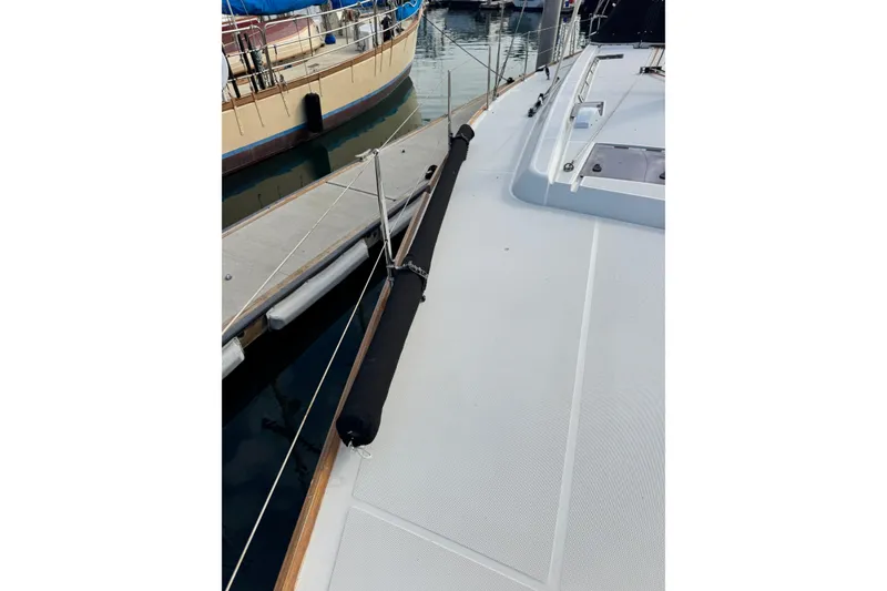 Slide: The Image of 2016 Beneteau Oceanis 48 yacht deck, docked at marina, showing sleek design and rigging. - 40