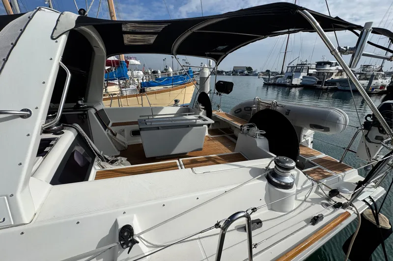 Slide: The Image of 2016 Beneteau Oceanis 48 sailboat cockpit with canopy, docked in a marina. - 5