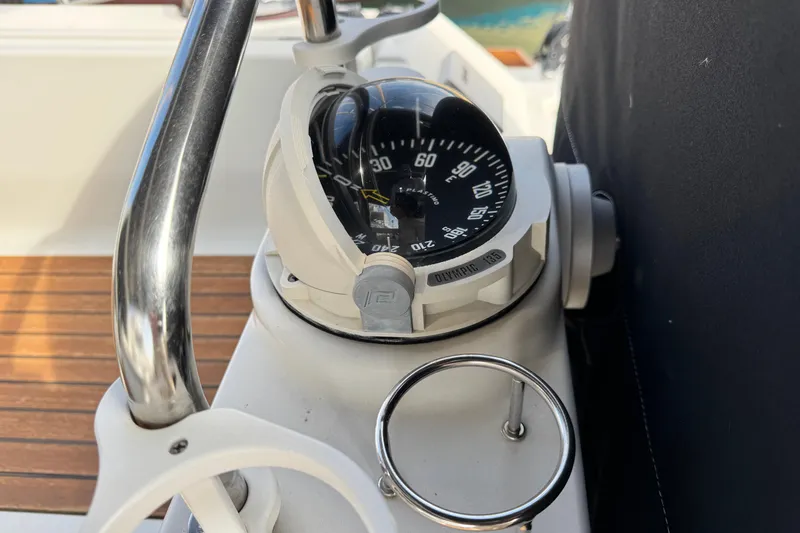 Slide: The Image of Compass on 2016 Beneteau Oceanis 48 yacht, featuring sleek design and wooden deck. - 7