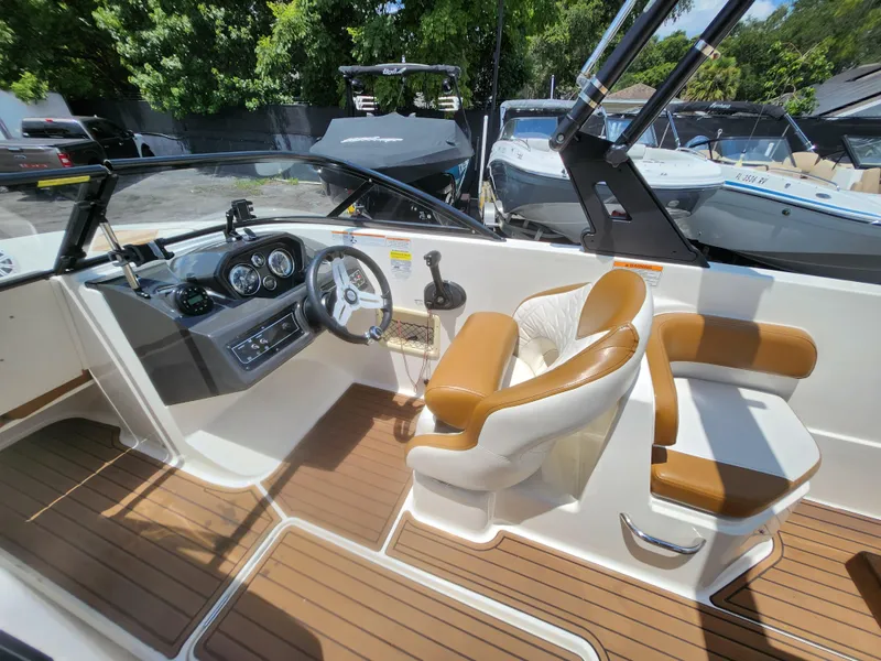 Slide: The Image of 2021 Bayliner VR6 Bowrider OB interior with steering wheel and seating. - 11