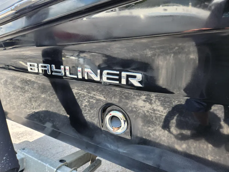Slide: The Image of 2021 Bayliner VR6 Bowrider OB boat, close-up of logo on black hull. - 5