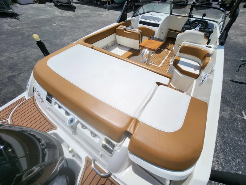 Slide: The Image of 2021 Bayliner VR6 Bowrider OB with tan and white seating, spacious deck, and modern controls. - 7