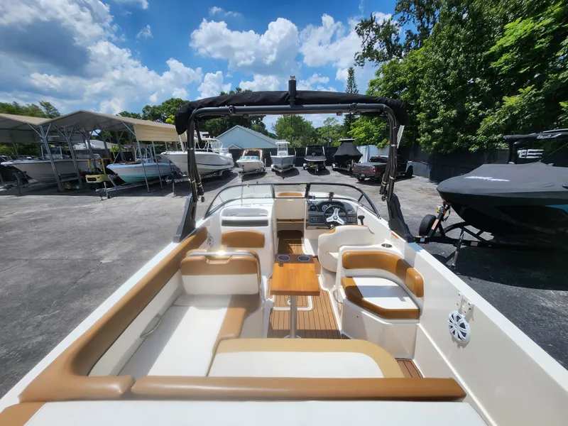 Slide: The Image of 2021 Bayliner VR6 Bowrider OB with spacious seating, docked under a sunny sky. - 8