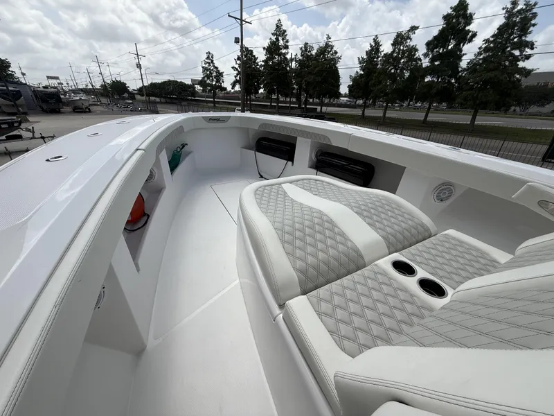 Slide: The Image of 2024 Front Runner 39 CC boat interior with quilted seating and cup holders. - 12