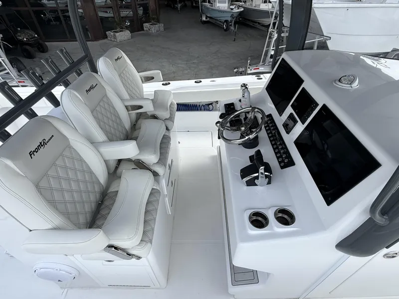 Slide: The Image of 2024 Front Runner 39 CC boat cockpit with luxury seating and advanced control panel. - 13