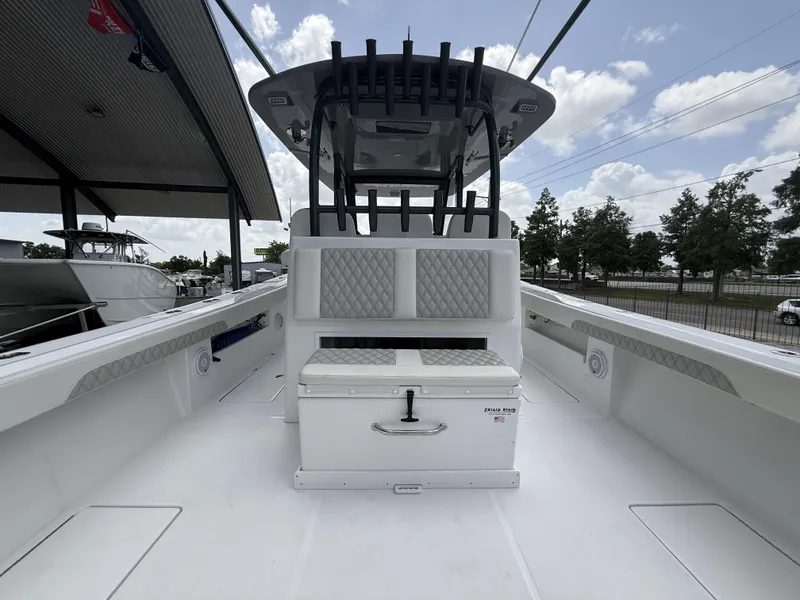 Slide: The Image of 2024 Front Runner 39 CC boat interior with seating and storage under a cloudy sky. - 17