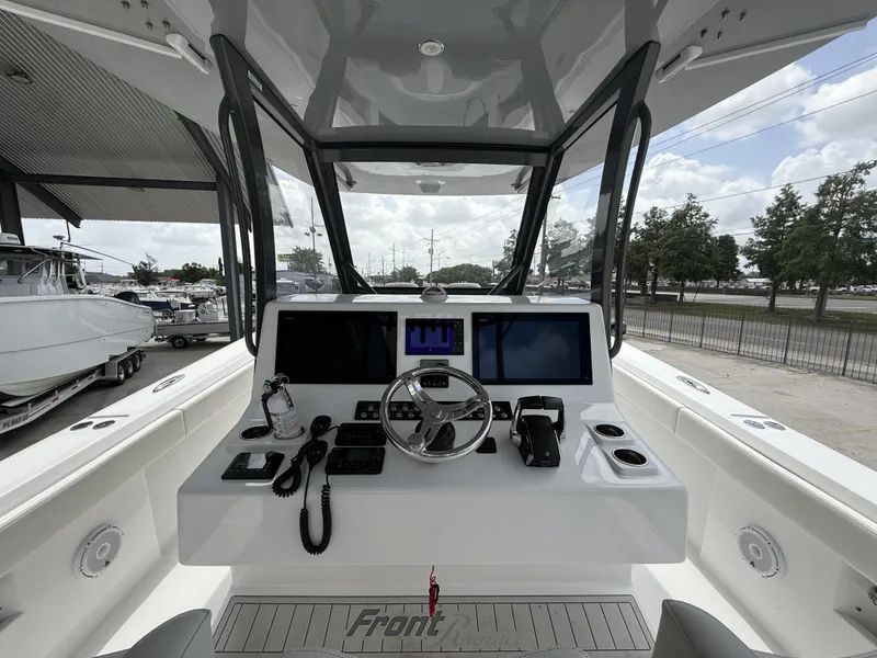 Slide: The Image of 2024 Front Runner 39 CC boat cockpit with modern navigation equipment and steering wheel. - 29