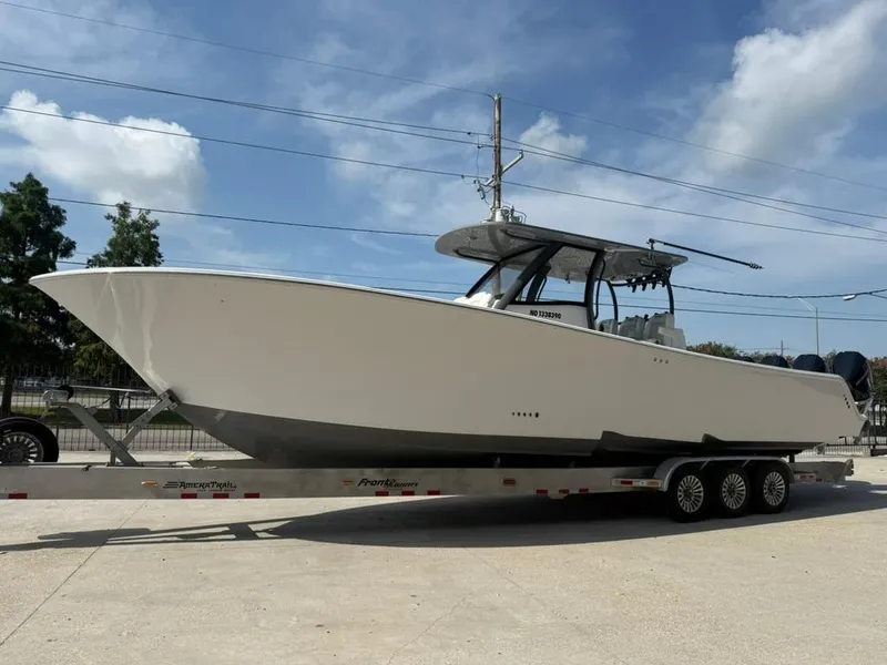 Slide: The Image of 2024 Front Runner 39 CC boat on trailer under clear sky. - 5