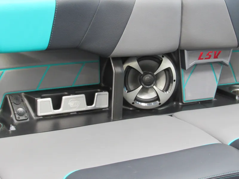 Slide: The Image of 2021 Malibu Wakesetter 23 LSV interior with gray and teal seating, featuring built-in speakers. - 10