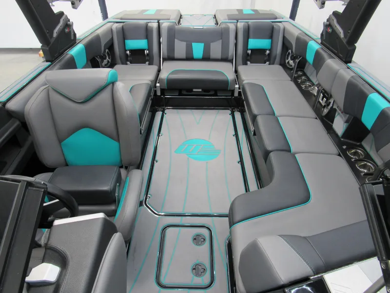 Slide: The Image of 2021 Malibu Wakesetter 23 LSV interior with gray and teal seating, speakers, and cup holders. - 16