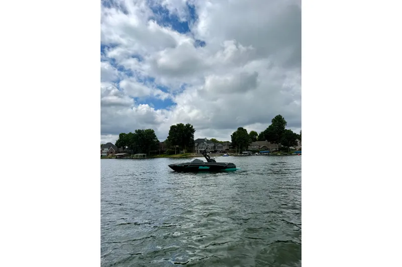 Slide: The Image of 2021 Malibu Wakesetter 23 LSV on a lake under cloudy skies. - 21