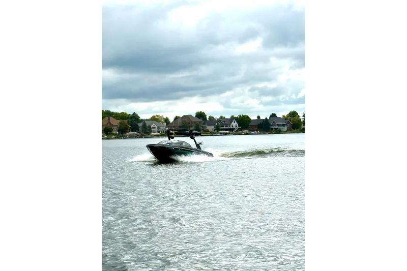 Slide: The Image of 2021 Malibu Wakesetter 23 LSV cruising on a lake under cloudy skies. - 22