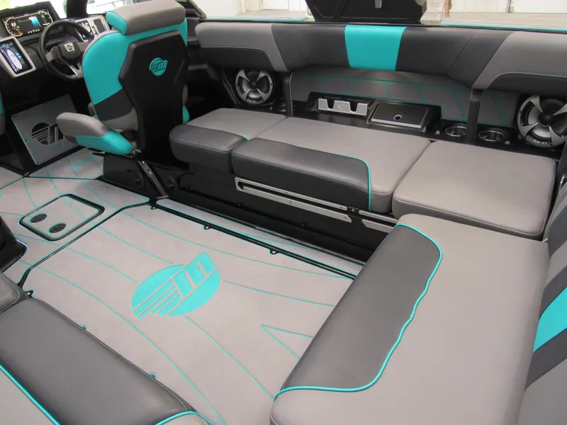 Slide: The Image of 2021 Malibu Wakesetter 23 LSV interior with gray and teal seating and sound system. - 6