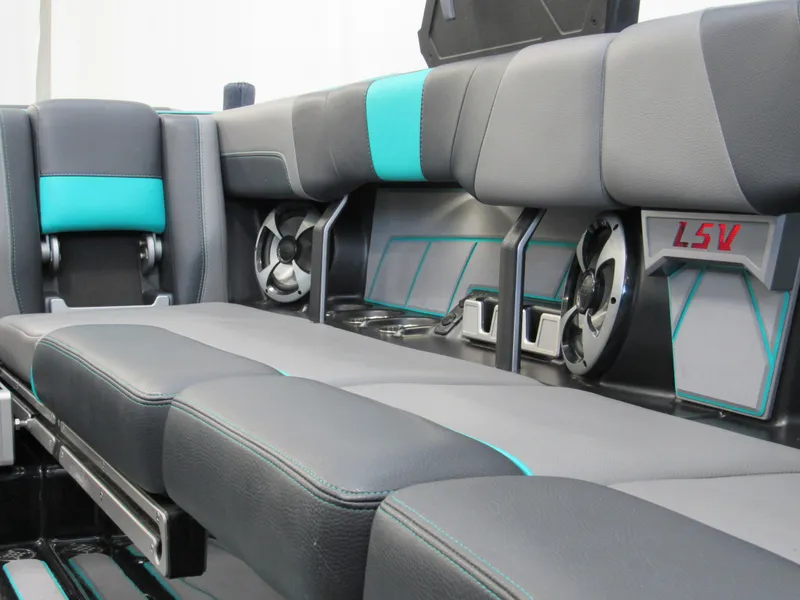 Slide: The Image of 2021 Malibu Wakesetter 23 LSV interior with gray and teal seating, cup holders, and speaker. - 9